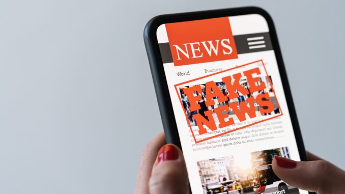 Online,Fake,News,On,A,Mobile,Phone.,Close,Up,Of