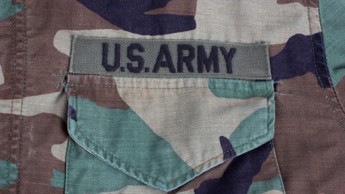 Us,Army,Branch,Tape,On,Woodland,Camouflage,Uniform,Background