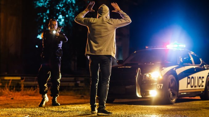 Middle,Aged,Caucasian,Police,Officer,Aims,At,A,Suspect.,Police